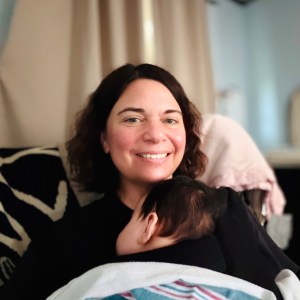 Pittsburgh area postpartum doula holds newborn to support new mom